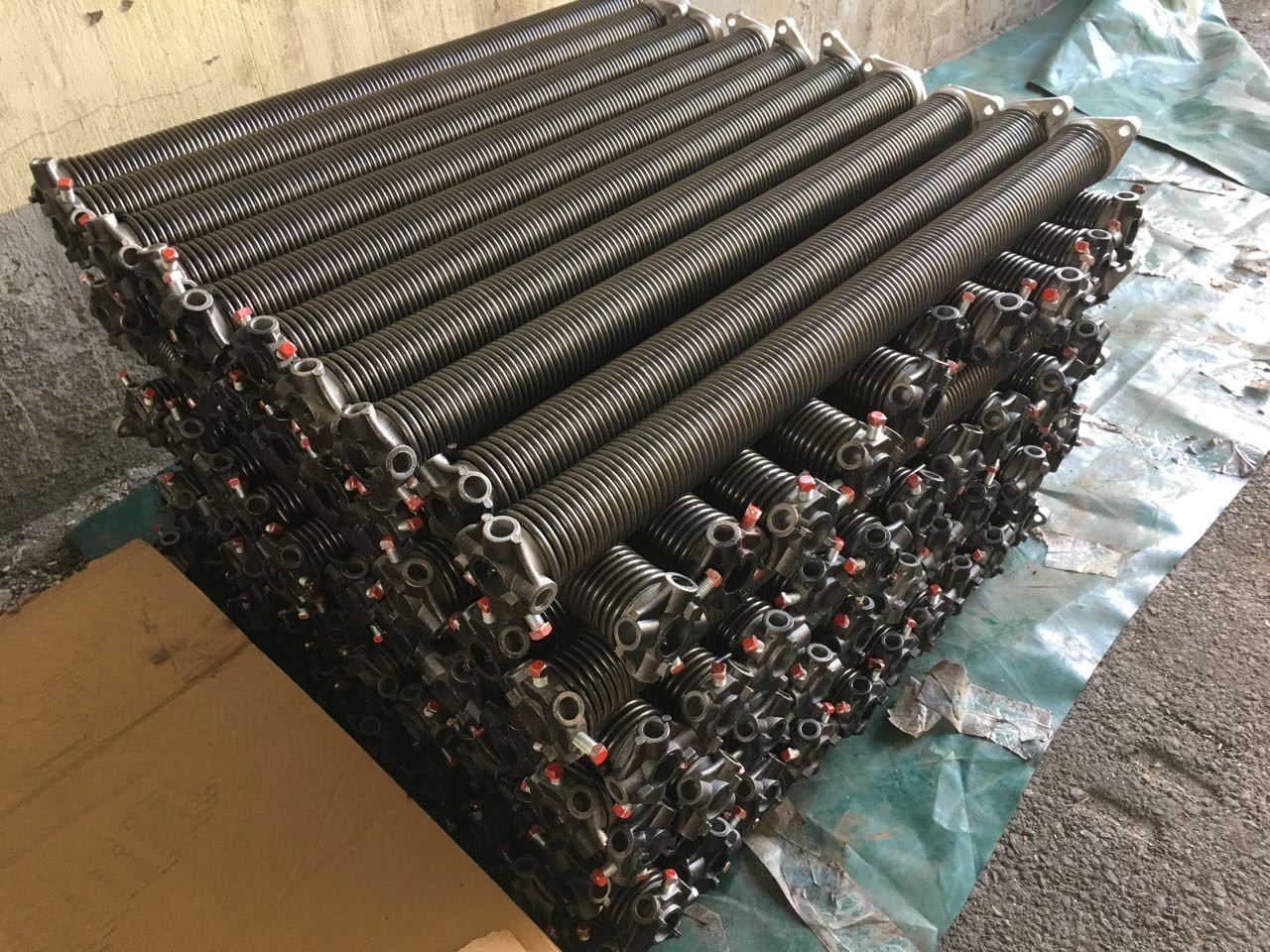 Stacked steel torsion springs with cast winding cones and red-tipped set screws